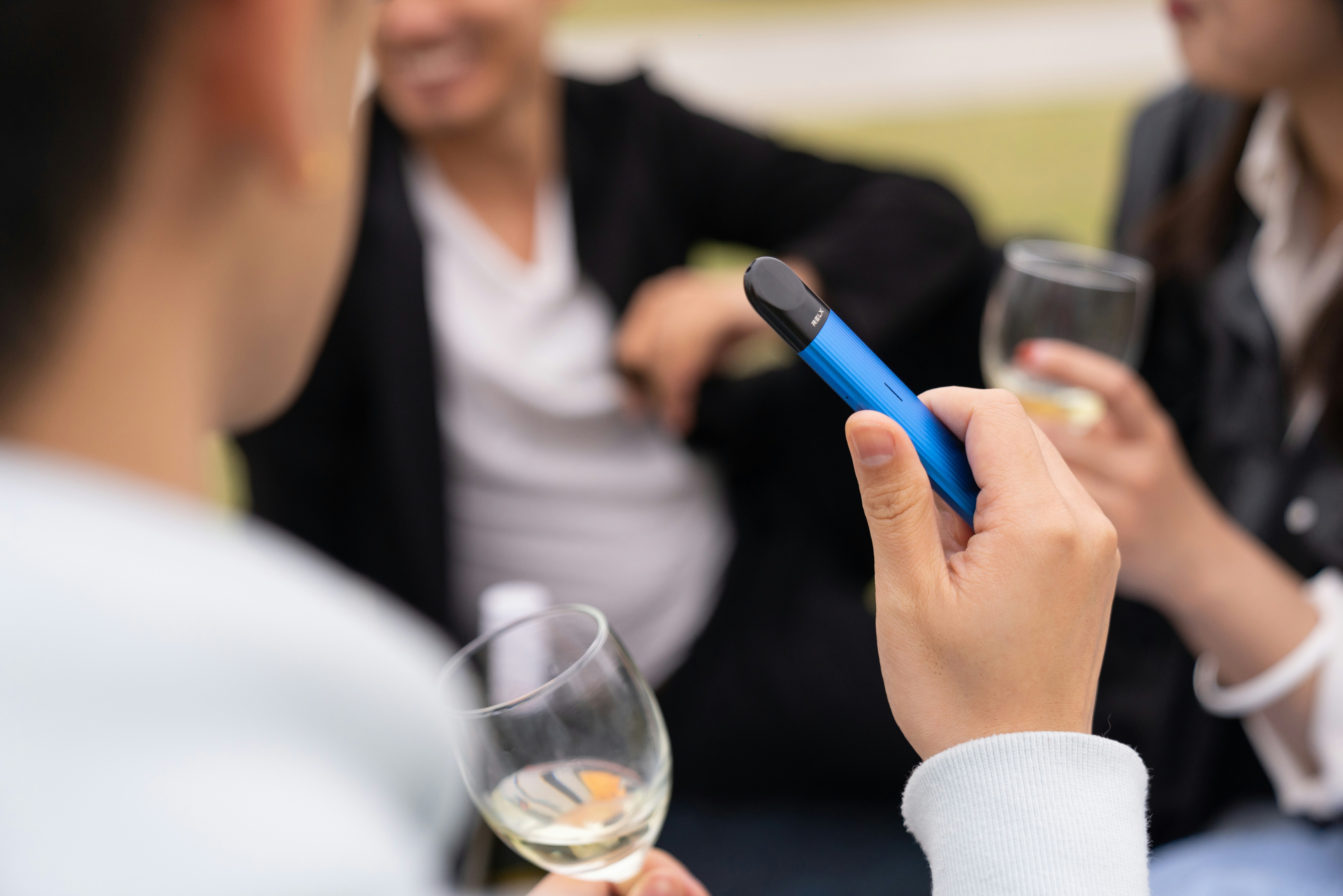 person holding a blue vape pen